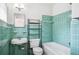 Retro bathroom featuring bright aqua tiles, classic fixtures, and a vintage design at 311 Cortland Ave, Winter Park, FL 32789
