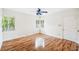 A bright bedroom with hardwood floors, two windows, and a ceiling fan at 311 Cortland Ave, Winter Park, FL 32789