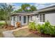 Charming single-story home exterior with a welcoming entrance and well-manicured landscaping at 311 Cortland Ave, Winter Park, FL 32789