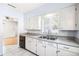 Traditional-style kitchen showcasing white cabinets, matching appliances, and tile flooring at 311 Cortland Ave, Winter Park, FL 32789