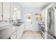 Classic kitchen features white cabinets, stainless steel appliances and a door to the exterior at 311 Cortland Ave, Winter Park, FL 32789