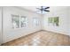 Bright living room with white walls, tile floors, ceiling fan, and natural light at 311 Cortland Ave, Winter Park, FL 32789