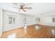 Bright living room featuring wood floors, white walls, and multiple windows for natural light at 311 Cortland Ave, Winter Park, FL 32789