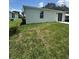 Expansive backyard with fresh grass and sliding glass doors that bring the outdoors inside at 320 W Necho Ave, Lake Alfred, FL 33850
