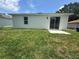 Expansive backyard with fresh grass and sliding glass doors that bring the outdoors inside at 320 W Necho Ave, Lake Alfred, FL 33850