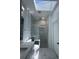 This gorgeous bathroom offers elegant marble floors and a glass enclosed shower with a stunning skylight overhead at 320 W Necho Ave, Lake Alfred, FL 33850