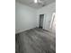 This bedroom features wood-look flooring and an open closet at 320 W Necho Ave, Lake Alfred, FL 33850
