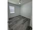 A bright bedroom with light gray floors and a ceiling fan for added comfort at 320 W Necho Ave, Lake Alfred, FL 33850
