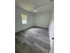Bright bedroom featuring sleek gray wood floors, a ceiling fan, and a window that streams in plenty of natural light at 320 W Necho Ave, Lake Alfred, FL 33850