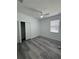 This bedroom features wood-look flooring, a ceiling fan, and closet at 320 W Necho Ave, Lake Alfred, FL 33850