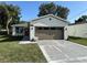 Newly renovated single-Gathering home with a freshly painted exterior, a new driveway, and well-maintained landscaping at 320 W Necho Ave, Lake Alfred, FL 33850
