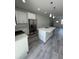 Open concept kitchen and living area with stainless appliances and center island at 320 W Necho Ave, Lake Alfred, FL 33850