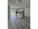 Open floor plan boasts kitchen island with quartz countertop and seating at 320 W Necho Ave, Lake Alfred, FL 33850
