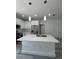 Kitchen island with pendant lighting and stainless steel faucet at 320 W Necho Ave, Lake Alfred, FL 33850