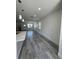 Open-concept floorplan with gray vinyl floors and recessed lighting at 320 W Necho Ave, Lake Alfred, FL 33850