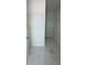 Spacious walk-in closet featuring clean white walls and shelving, as well as beautiful tiled floors at 320 W Necho Ave, Lake Alfred, FL 33850