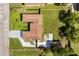 A bird's-eye view shows the home's layout, roof, a long driveway and a spacious backyard with new fence at 338 Henry Butts Dr, Daytona Beach, FL 32114