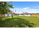 Expansive backyard with lush green grass, a storage shed and a new wooden fence providing privacy at 338 Henry Butts Dr, Daytona Beach, FL 32114