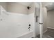 Updated bathroom with a shower and tub combination and convenient built-in shelving at 338 Henry Butts Dr, Daytona Beach, FL 32114