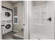 Bathroom features a shower stall and a laundry area with stacked washer and dryer at 338 Henry Butts Dr, Daytona Beach, FL 32114