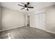 This bedroom offers neutral paint, wood-look flooring, and a ceiling fan for added comfort at 338 Henry Butts Dr, Daytona Beach, FL 32114