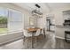 Bright dining room featuring hardwood floors, a modern light fixture, and an open layout to the kitchen at 338 Henry Butts Dr, Daytona Beach, FL 32114