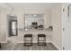 Open view from dining to the renovated kitchen with granite countertops and breakfast bar seating at 338 Henry Butts Dr, Daytona Beach, FL 32114