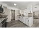 Bright kitchen featuring white cabinets, granite countertops, hardwood floors, and stainless appliances at 338 Henry Butts Dr, Daytona Beach, FL 32114