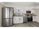 Modern kitchen featuring stainless steel appliances, white cabinets, granite countertops, and hardwood floors at 338 Henry Butts Dr, Daytona Beach, FL 32114