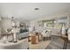 Cozy living room featuring neutral paint, hardwood floors, a large window, and stylish furnishings at 338 Henry Butts Dr, Daytona Beach, FL 32114