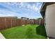 The side yard of the property features new artificial turf and a wooden fence for privacy at 3430 Arbutus Ln, Winter Park, FL 32792