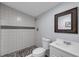 A bright bathroom featuring a shower with stone flooring and accent stripe at 3430 Arbutus Ln, Winter Park, FL 32792