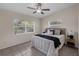 Serene bedroom with large windows, tile flooring, and a ceiling fan for added comfort at 3430 Arbutus Ln, Winter Park, FL 32792