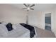 Bedroom with a ceiling fan, tile flooring, and a view of the en suite bathroom at 3430 Arbutus Ln, Winter Park, FL 32792