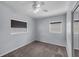 This bedroom has grey walls and two windows that provide natural light at 3430 Arbutus Ln, Winter Park, FL 32792