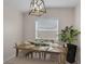 Cozy dining area with a wooden table, bench seating, and a stylish light fixture at 3430 Arbutus Ln, Winter Park, FL 32792