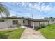 Charming single-story home with a well-maintained lawn and inviting front porch at 3430 Arbutus Ln, Winter Park, FL 32792
