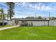 Front yard view of a cozy home with a lush green lawn and a modern facade at 3430 Arbutus Ln, Winter Park, FL 32792