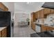 Open-concept kitchen featuring wood cabinets, stainless appliances, and dining area at 3430 Arbutus Ln, Winter Park, FL 32792