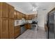 Functional kitchen with wood cabinets, stainless steel appliances, and ample countertop space at 3430 Arbutus Ln, Winter Park, FL 32792