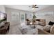 Comfortable living room with a ceiling fan, tile floors, and access to outdoor pool area at 3430 Arbutus Ln, Winter Park, FL 32792