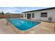 A backyard swimming pool features a modern ladder and is surrounded by a concrete patio at 3430 Arbutus Ln, Winter Park, FL 32792