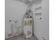 A utility room featuring a water heater and some shelving at 3430 Arbutus Ln, Winter Park, FL 32792