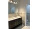 Bathroom with a double sink vanity, stylish fixtures, and a large mirror at 3431 Orchid Dr, Indian Lake Estates, FL 33855