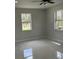 Bedroom featuring tile floors, base trim and two windows at 3431 Orchid Dr, Indian Lake Estates, FL 33855