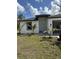 Well-maintained home featuring lush green grass and healthy palm trees in the front yard at 3431 Orchid Dr, Indian Lake Estates, FL 33855