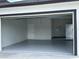 Spacious two-car garage featuring an epoxy floor, ample lighting, and storage space at 3431 Orchid Dr, Indian Lake Estates, FL 33855