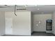 Spacious garage with white painted walls and tile flooring at 3431 Orchid Dr, Indian Lake Estates, FL 33855