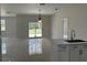 Open-concept kitchen with stainless steel appliances and a sliding glass door at 3431 Orchid Dr, Indian Lake Estates, FL 33855