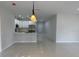 Inviting living room with tile flooring and a kitchen showcasing stainless steel appliances at 3431 Orchid Dr, Indian Lake Estates, FL 33855